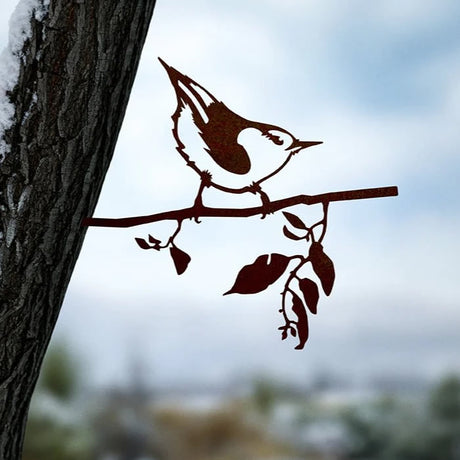 Metal Nuthatch silhouette perched on a branch, made from durable Corten Steel, designed for garden decoration. The bird's detailed cut captures the essence of a nuthatch.