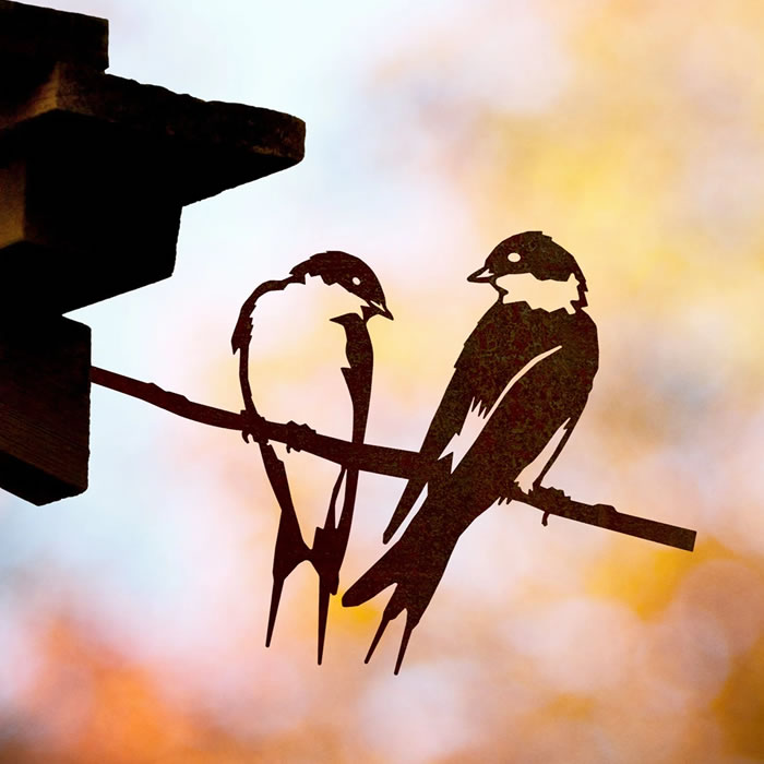 Pair of Swallows silhouette on a branch, crafted from durable Corten Steel, designed to develop a unique patina over time, perfect for garden decoration.