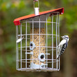 The Nuttery Roundhaus Seed Feeder, Red, with a woodpecker perched on it, showcasing its durable metal design and large seed capacity.