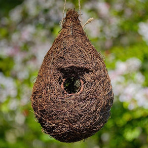 Hanging Roosting Nest Pocket For Small Birds, featuring a sturdy rattan frame with an overhang roof and brushwood finish, ideal for garden birds like robins.