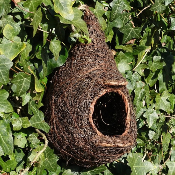 Hanging Roosting Nest Pocket for Small Birds: A close-up of a bird nest pocket nestled in a plant, featuring a sturdy frame and welcoming entrance.