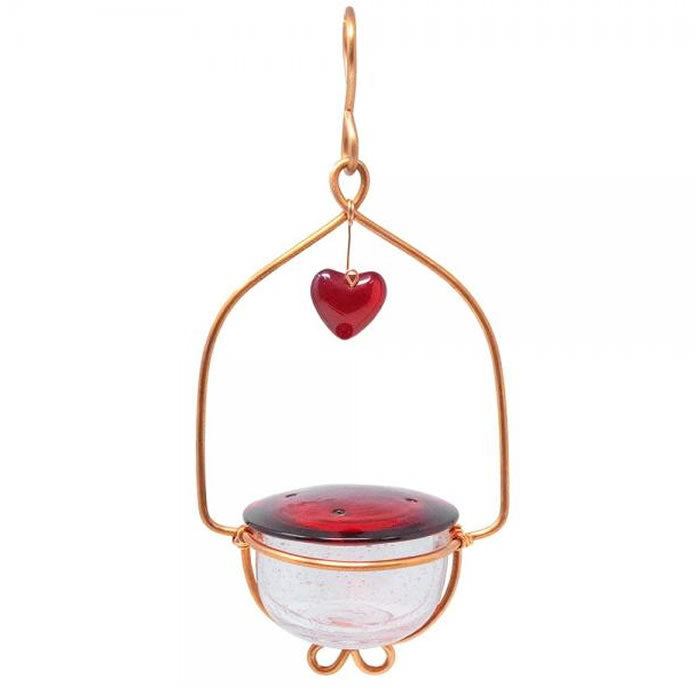 Holland Hill Heart Hummingbird Feeder with cherry red glass lid, heart-shaped copper wire frame, and clear dish, featuring 4 feeding ports and a copper hanging hook.