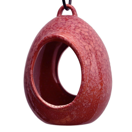 Egg Fly Through Feeder with a built-in hanging loop, deep interior, and drainage holes. High-fired stoneware, easy to fill and clean, and suitable for bird perching.