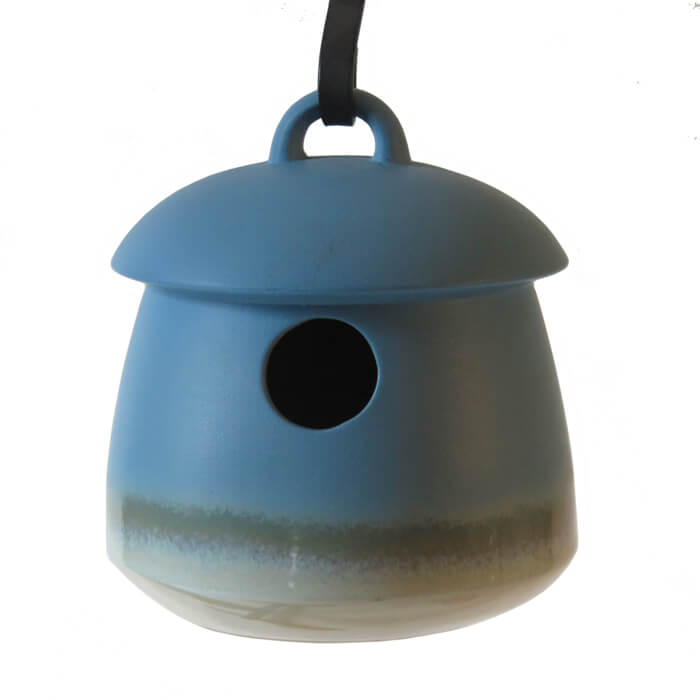 Return Bird Home, Soft Blue, stoneware birdhouse with a 1-1/8 inch entrance, hanging from a black cord. Features a drainage hole and removable plug for cleaning.