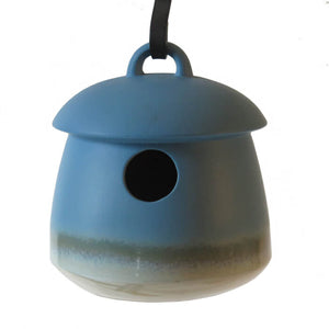 Return Bird Home, Soft Blue, stoneware birdhouse with a 1-1/8 inch entrance, hanging from a black cord. Features a drainage hole and removable plug for cleaning.