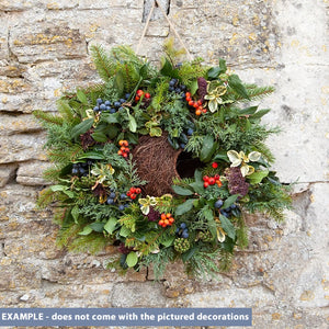 Wreath Bird House Nester hanging on a wall, showcasing its hand-woven design, perfect for attracting birds and enhancing outdoor decor with a rustic touch.