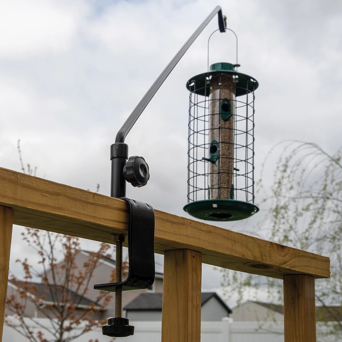 Swing Arm Deck Hanger on a wooden railing, featuring a 360-degree swivel arm for easy bird feeder refills, available in 23 or 44-inch sizes.