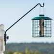 Screw Mount Swing Arm Hanger, 23 or 44 Inch, shown mounted on a pole with a green bird feeder, featuring a 360-degree swivel arm for easy refills.