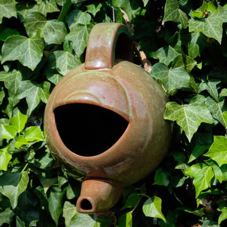 Teapot Style Bird Nester in brown ceramic, designed as a teapot with a hole, perfect for nesting birds in your garden.