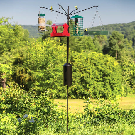 Squirrel-Proof Four Arm Bird Feeding Station with birds perched, featuring a squirrel baffle and durable black pole, standing in an outdoor setting.