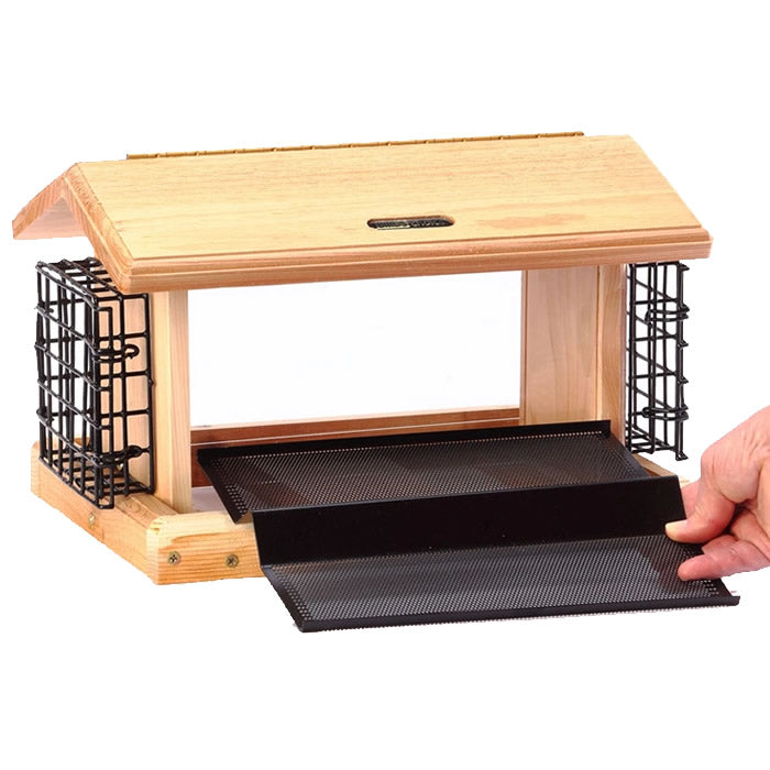 Hand holding Birds Choice 5 Qt. 2-Sided Hopper with Suet, featuring a wooden design, black mesh, and removable seed tray for easy filling.