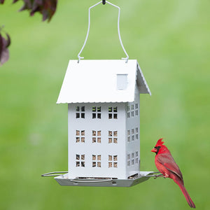 White Farmhouse Bird Feeder with a red bird perched, showcasing four feeding ports and a classic design, ideal for attracting various birds in smaller spaces.