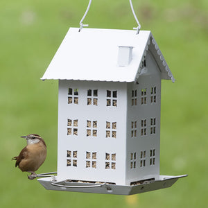 White Farmhouse Bird Feeder with a bird perched, featuring four feeding ports, wide perches, and a classic design for smaller spaces.