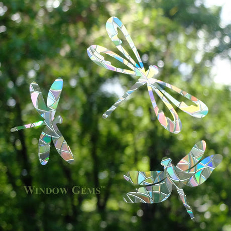 Dragonfly Window Gems, Set of 9, featuring assorted prismatic dragonfly designs on a window to prevent bird strikes and add elegance.