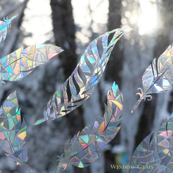 Feather Window Gems, Set of 9: Close-up of feather decals on a window, designed to prevent bird strikes and add elegance.