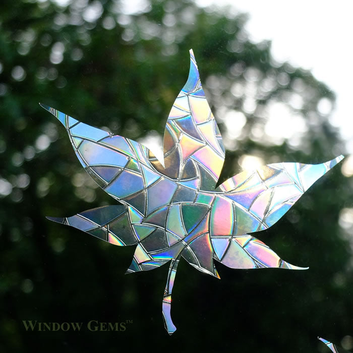 Mixed Leaves Window Gems, Set of 9, featuring iridescent glass leaf decals designed to prevent bird strikes and add elegance to windows.