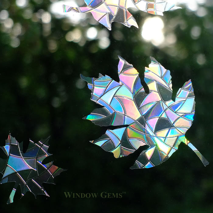 Mixed Leaves Window Gems, Set of 9, prismatic decals shaped like leaves, designed to prevent bird strikes by breaking up window reflections.