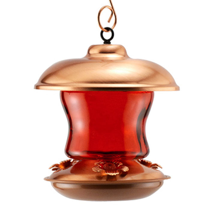 16 oz. Ruby Glass Hummingbird Feeder with decorative red metal flower ports and a protective copper top. Features a durable red glass reservoir and three feeding ports.