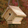 Cedar Traditional Wren House with 1-1/4 inch entry hole, hanging cable, built-in ventilation, and drainage, made from weather-resistant cedar wood.