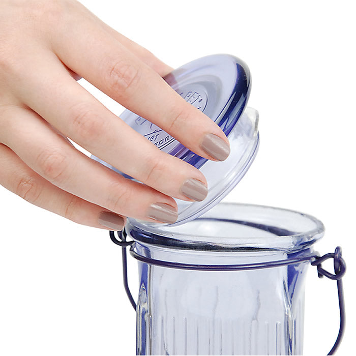 Hand opening the Lavender Field Top-Fill Glass Hummingbird Feeder, showcasing its easy-to-remove lid for mess-free filling and cleaning.