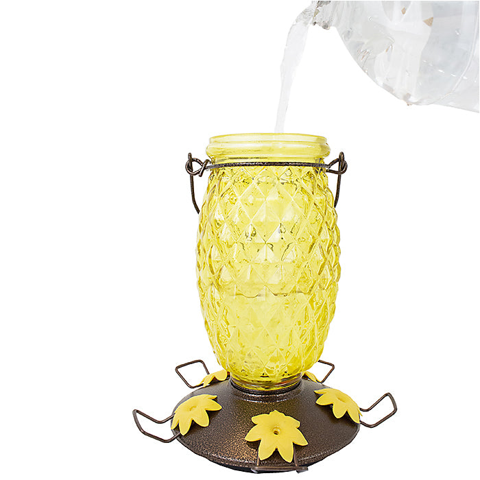 Perky-Pet Pineapple Top-Fill Hummingbird Feeder with yellow glass, black handle, and ant moat. 28 oz. capacity with 5 feeding ports.