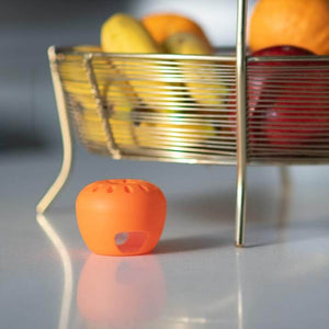 Safer Home Fruit Fly Trap, apple-shaped with built-in window, shown in a fruit basket, designed to lure and trap adult fruit flies effectively.