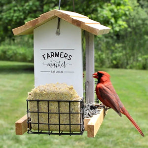 Farmhouse Hopper Feeder with bird perched on it, featuring a spacious design for large birds, cedar build, and dual suet cake holders.