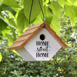 Farmhouse Wren House hanging from a tree, featuring a cedar build, 1-1/8 inch entrance hole, air vents, and cleanout doors for easy maintenance.