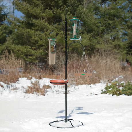 Yard Tree Bird Feeder Hanger in snow with birds feeding, showcasing adjustable hooks and anti-tip base, creating a versatile outdoor birding station.