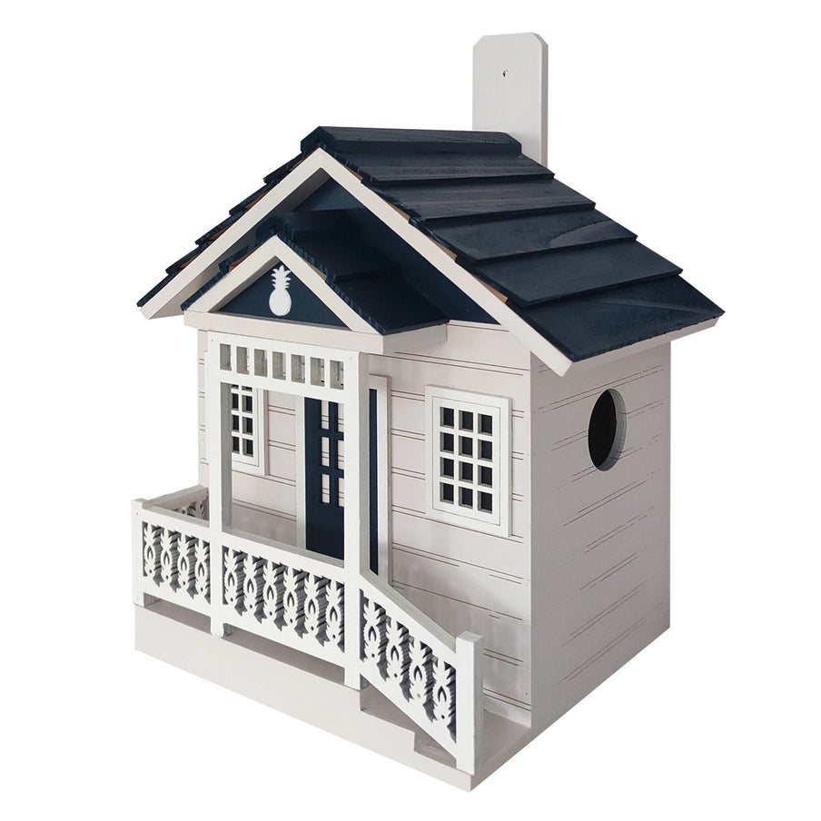 Welcome Home Cottage Birdhouse with pineapple accents, featuring a porch, ventilation, and a 1.25 entrance for small birds. Ideal for gardens.